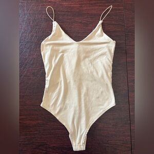 Women’s size XS cream colored bodysuit with snaps